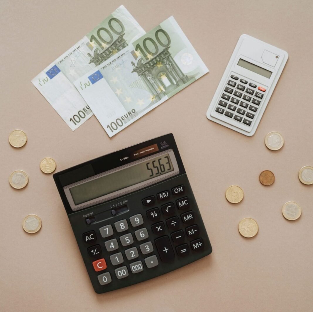 Flat lay of calculators and Euro currency, depicting financial calculations and budget management.